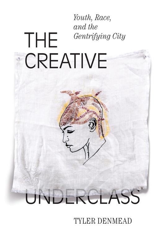 Book cover showing a piece of white material printed with a three-quarter portrait of unknown person.