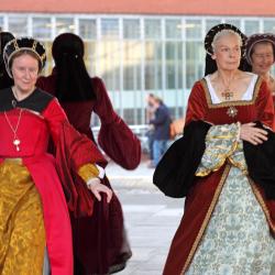 A demonstration of past legacies, with four actresses in Medieval clothing performing the roles of women in that time.