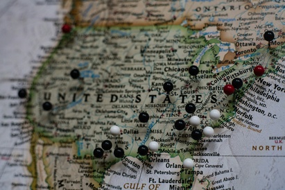 Map of the United States with map pins on different cities.