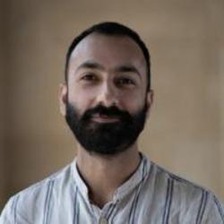 Portrait head-shot of Dr Ali Meghji