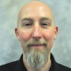 Portrait head-shot of Dr Joe Sutliff Sanders