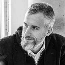Portrait head-shot of Dr Tyler Denmead