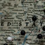 Map of the United States with map pins on different cities.